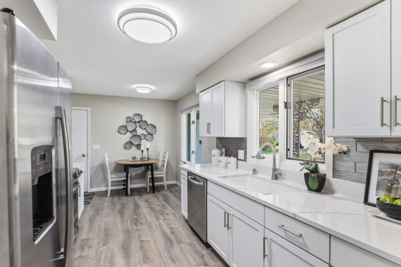 Spectacular move-in ready, mid-century rambler sitting pretty on a quiet, winding street, lined with gorgeous mature trees.