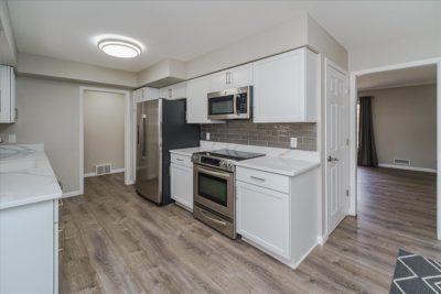 Spectacular move-in ready, mid-century rambler sitting pretty on a quiet, winding street, lined with gorgeous mature trees.